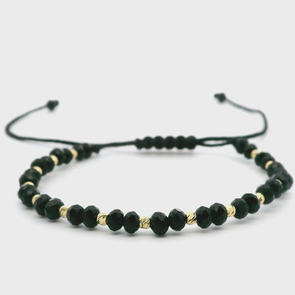 Elegantes schwarzes Armband mit 585er goldenen Kugeln